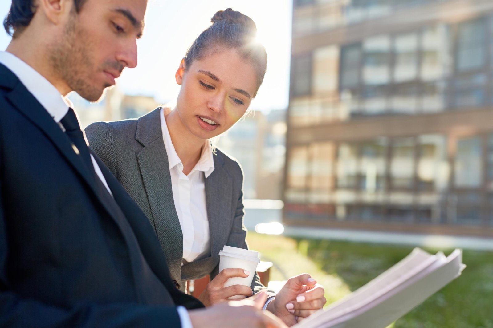 Property managers reviewing documents outdoors in Vancouver while discussing rental property management services and strategies.